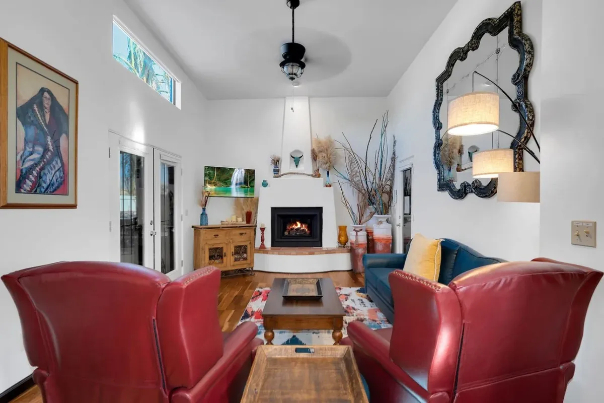 Tucson living room with leather chairs, fireplace, colorful rug and desert-inspired decor