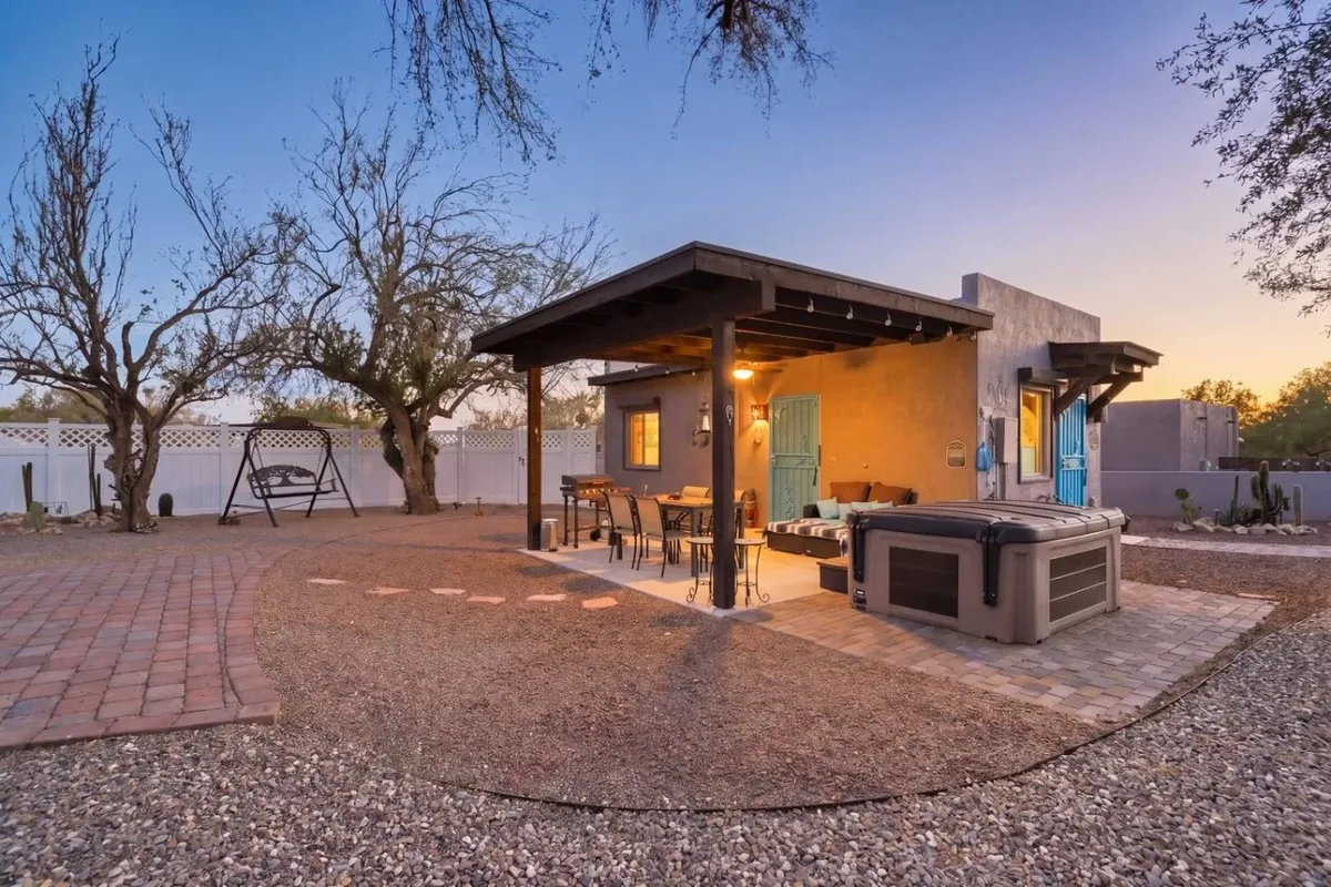 Tucson casita patio with a hot tub, dining table, swing and desert landscaping